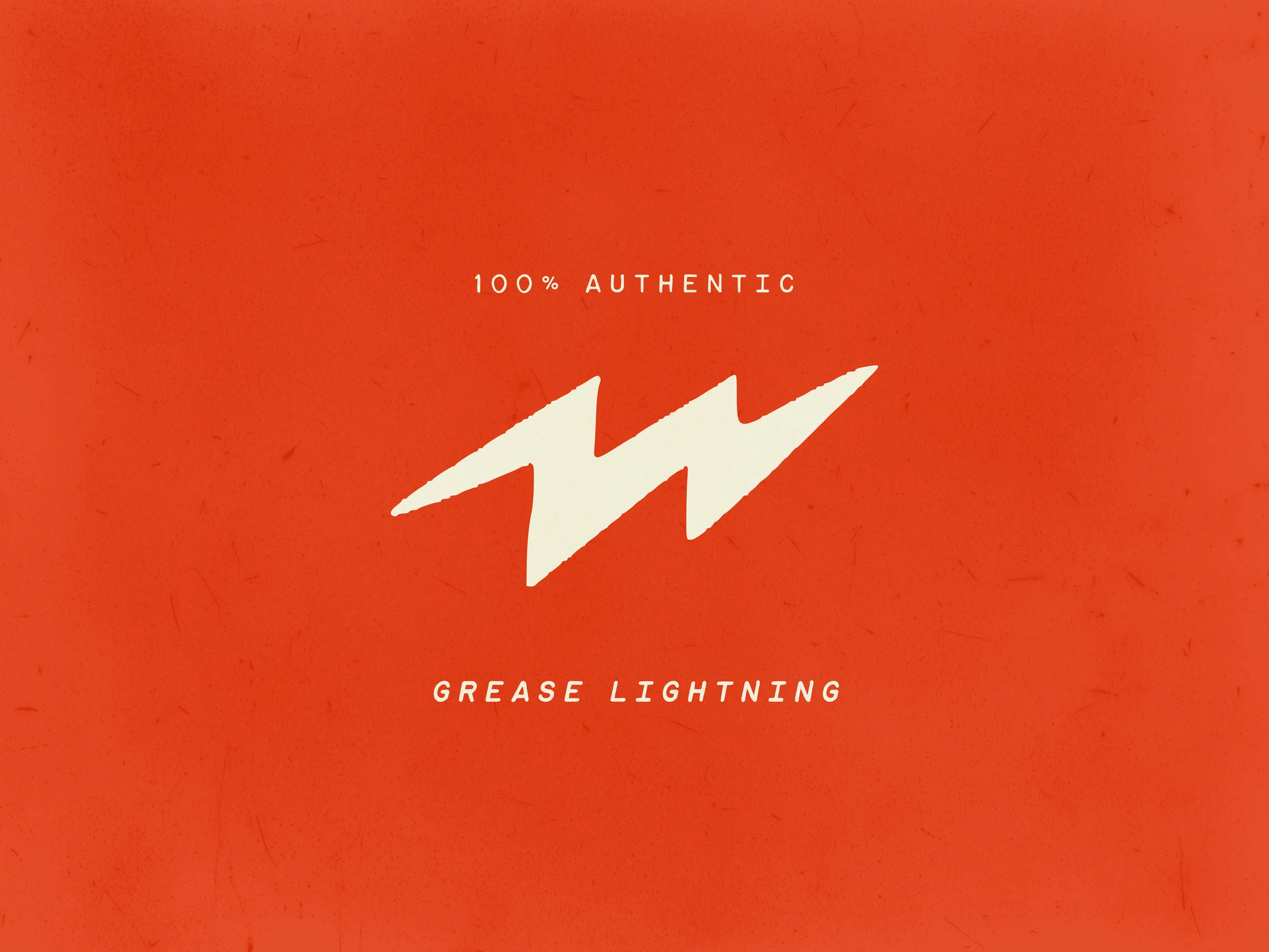 A lightning-bolt mark with the slug 100% Authentic Grease Lightning.