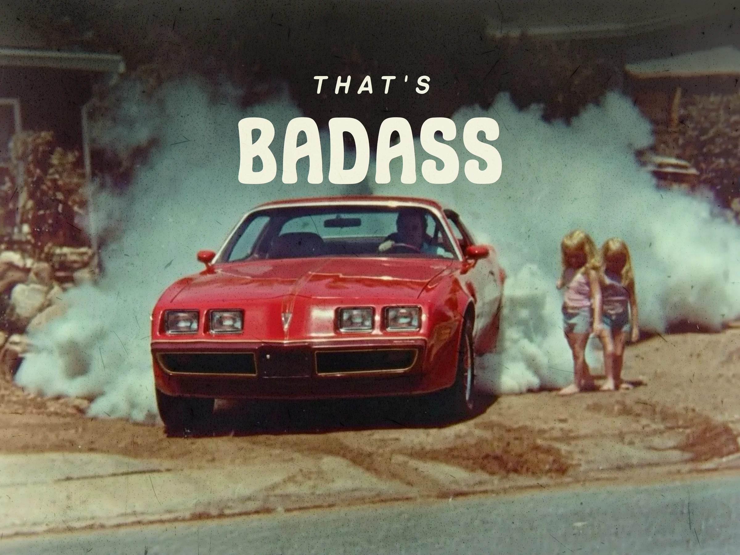 A red Trans Am doing a burnout in a driveway while two kids watch from a few feet away, with the words THAT'S BADASS overlaid.